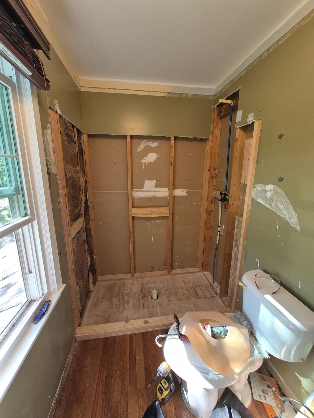 Old shower torn out down to the studs before rebuilding
