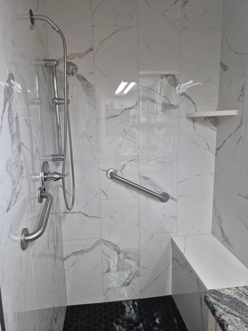 Walk-in shower with grab bars and bench